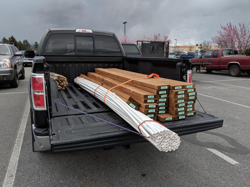 truck bed loaded with pvc pipes and 2x6 planks