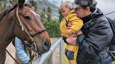 randy up a kid to look at a horse