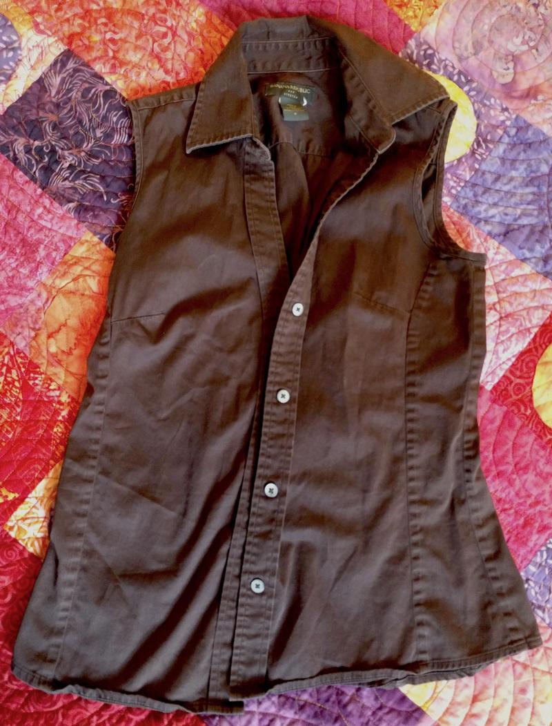 brown vest lying on a bed