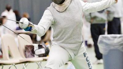 jacqueline in fencing gear on strip, lunging at an opponent during a college fencing tournament
