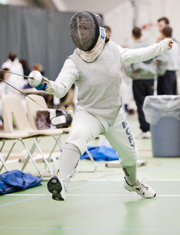 jacqueline in fencing gear on strip, lunging at an opponent during a college fencing tournament