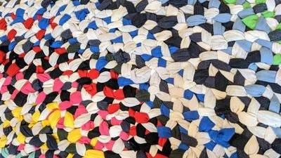 closeup of braided rag rug made from colorful tshirt strips