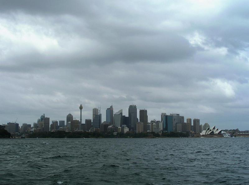 the skyline of Sydney, Australia across the water of the bay, the famous opera house on the right
