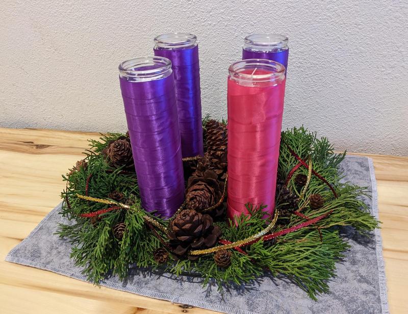 evergreen advent wreath with four tall candles
