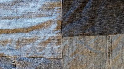 close up of blue jean fabric rectangles sewn together for a picnic blanket