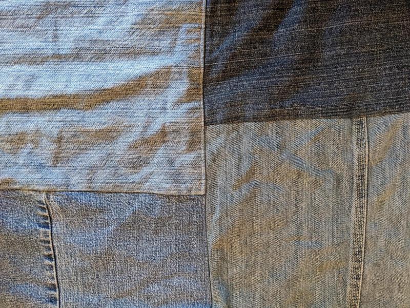close up of blue jean fabric rectangles sewn together for a picnic blanket