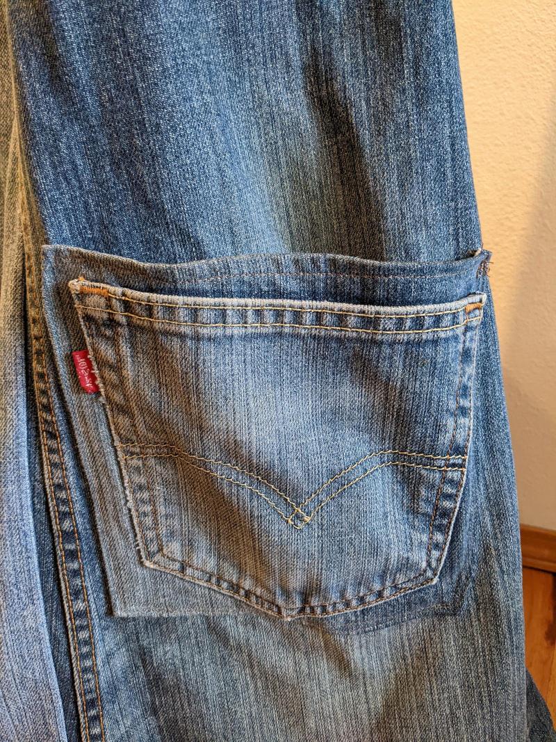 close up of a double blue jean pocket on an apron