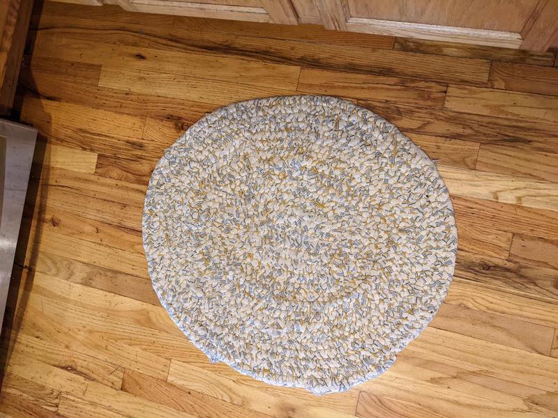 woven rag rug, an oval about two feet across, made from white and blue flannel sheets