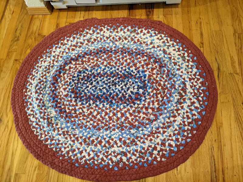 braided flannel rag rug woven into an oval about three feet across