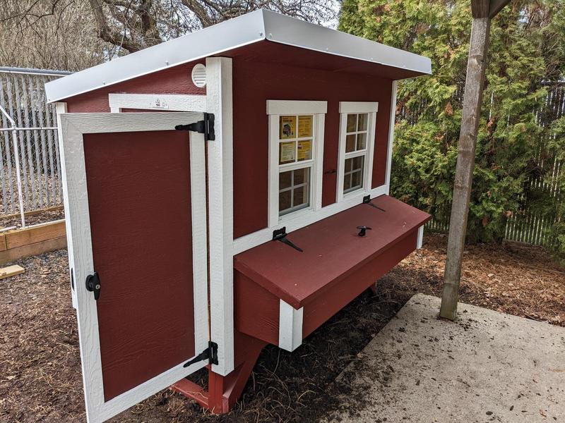 a large red and white chicken coop