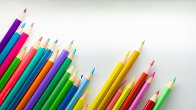 colored pencils with nice sharp points, staggered in a line at an angle, pointing to the top right
