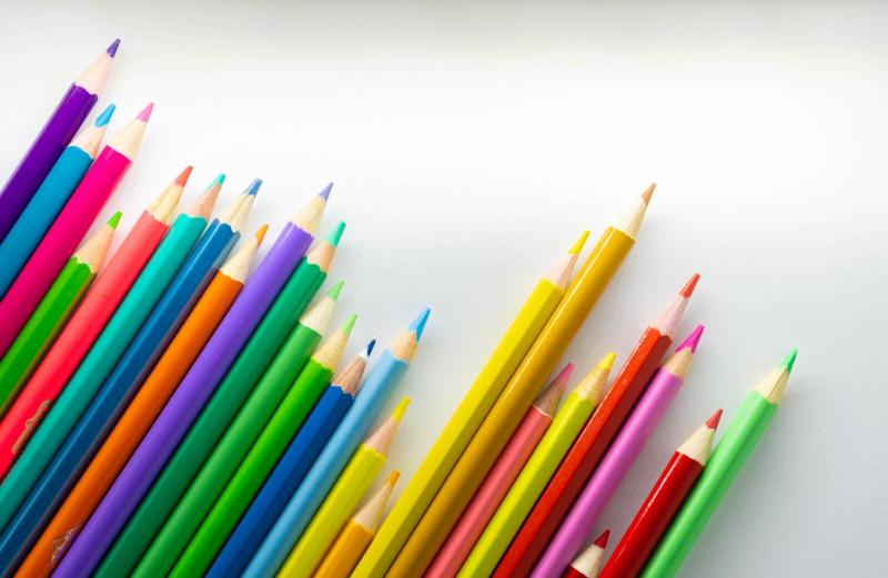 colored pencils with nice sharp points, staggered in a line at an angle, pointing to the top right