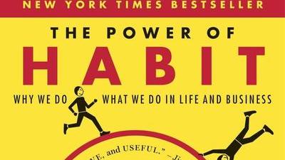 the cover of the book The Power of Habit by Charles Duhigg, featuring little people running around a stylized red hamster wheel on a constrasting yellow background