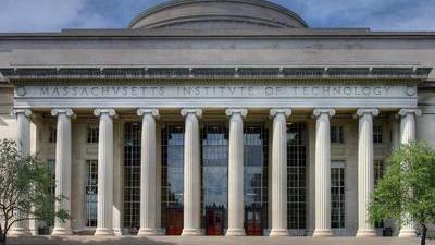 an academic building in classical style with a bunch of columns and a rounded down on top with roman lettering saying massachusetts institute of technology